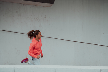 Image showing Women in sports clothes running in a modern urban environment. The concept of a sporty and healthy lifestyle