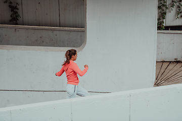 Image showing Women in sports clothes running in a modern urban environment. The concept of a sporty and healthy lifestyle