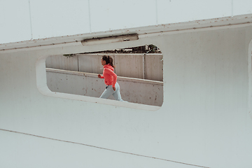 Image showing Women in sports clothes running in a modern urban environment. The concept of a sporty and healthy lifestyle