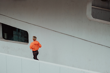 Image showing Women in sports clothes running in a modern urban environment. The concept of a sporty and healthy lifestyle