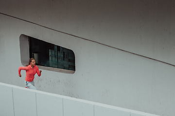 Image showing Women in sports clothes running in a modern urban environment. The concept of a sporty and healthy lifestyle