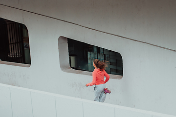 Image showing Women in sports clothes running in a modern urban environment. The concept of a sporty and healthy lifestyle