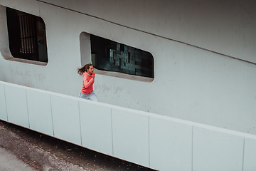 Image showing Women in sports clothes running in a modern urban environment. The concept of a sporty and healthy lifestyle