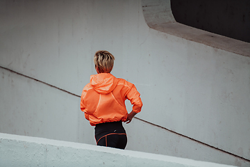 Image showing Women in sports clothes running in a modern urban environment. The concept of a sporty and healthy lifestyle