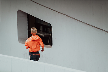 Image showing Women in sports clothes running in a modern urban environment. The concept of a sporty and healthy lifestyle