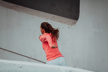 Image showing Women in sports clothes running in a modern urban environment. The concept of a sporty and healthy lifestyle