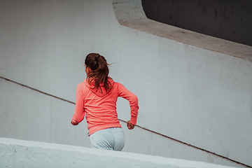 Image showing Women in sports clothes running in a modern urban environment. The concept of a sporty and healthy lifestyle