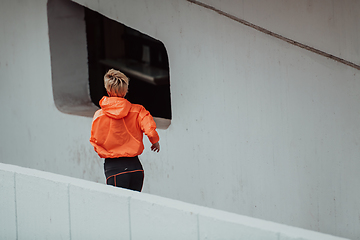 Image showing Women in sports clothes running in a modern urban environment. The concept of a sporty and healthy lifestyle