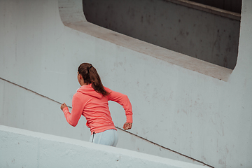 Image showing Women in sports clothes running in a modern urban environment. The concept of a sporty and healthy lifestyle