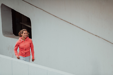 Image showing Women in sports clothes running in a modern urban environment. The concept of a sporty and healthy lifestyle