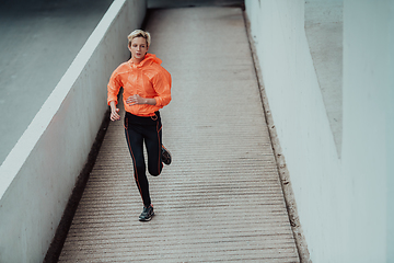 Image showing Women in sports clothes running in a modern urban environment. The concept of a sporty and healthy lifestyle