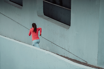 Image showing Women in sports clothes running in a modern urban environment. The concept of a sporty and healthy lifestyle