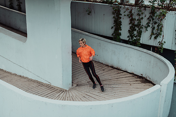 Image showing Women in sports clothes running in a modern urban environment. The concept of a sporty and healthy lifestyle