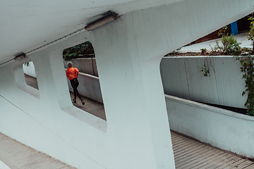 Image showing Women in sports clothes running in a modern urban environment. The concept of a sporty and healthy lifestyle