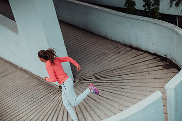 Image showing Women in sports clothes running in a modern urban environment. The concept of a sporty and healthy lifestyle