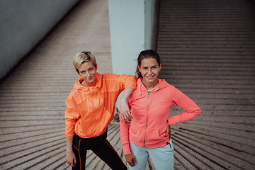 Image showing Two lgbt woman resting after a hard training in an urban environment