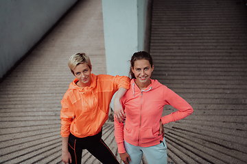 Image showing Two lgbt woman resting after a hard training in an urban environment