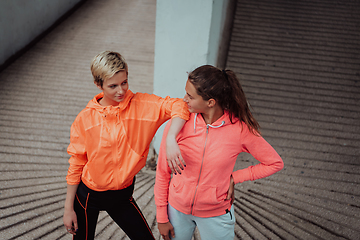 Image showing Two lgbt woman resting after a hard training in an urban environment