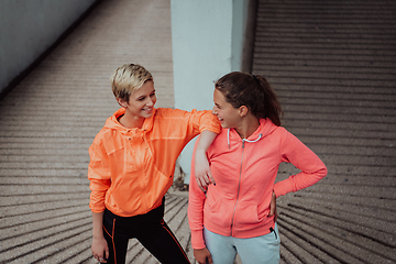 Image showing Two lgbt woman resting after a hard training in an urban environment