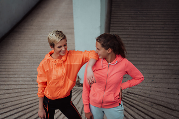 Image showing Two lgbt woman resting after a hard training in an urban environment