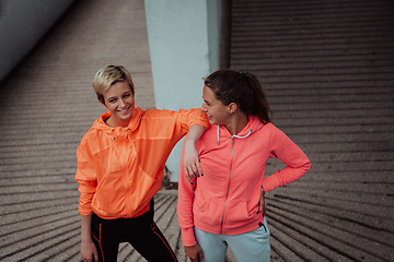 Image showing Two lgbt woman resting after a hard training in an urban environment