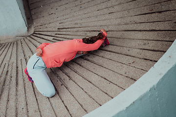 Image showing Fit attractive woman in sportswear stretching before jogging. Workout, sport, activity, fitness, vacation and training concept.