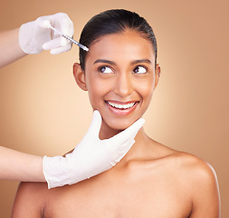 Image showing Woman, face injection and beauty with needle and dermatology, skincare with plastic surgery on studio background. Female, hands and smile, cosmetic procedure with facelift treatment and healthy skin