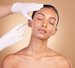 Image showing Woman, face and needle with beauty and dermatology, skincare with plastic surgery on studio background. Female, hands and skin injection, cosmetic procedure with facelift treatment and eyes closed