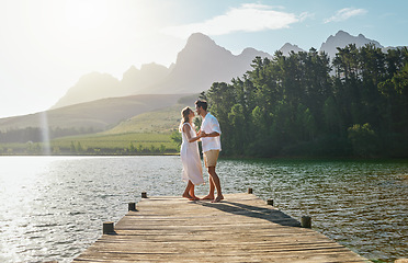 Image showing Love, couple and dance at lake pier, smile or bonding outdoors on vacation at sunrise. Dancing date, having fun and happy man and woman on anniversary celebration for romantic holiday at summer creek