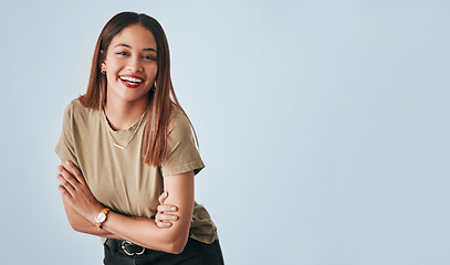 Image showing Portrait, mockup and laughter with an arms crossed woman in studio having fun on a gray background. Comic, comedy and humor with an attractive young female standing indoor feeling playful or carefree