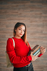 Image showing Serious, books and education with portrait of woman on wall background for learning, college and scholarship. University, knowledge and academic with female student for school, intelligent and campus