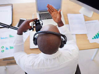 Image showing Laptop, headphones and black man with microphone for podcast, video call or live streaming in office. Business, marketing and top view of male entrepreneur with mic for content creation or radio host