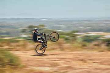 Image showing Extreme sports, bicycle and man cycling in the countryside for fitness, stunt and freedom. Nature, biking and sporty male cyclist training, practice and speed, action and free on Mexico dirt road