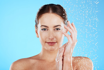 Image showing Shower portrait, water and woman in a studio feeling happy from cleaning and skincare. Wellness, splash and beauty routine of a female model with dermatology and self care with blue background