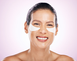 Image showing Face, skincare and woman with eye patches in studio isolated on a purple background. Dermatology portrait, cosmetics and happy, mature and female smile with facial mask for collagen and anti aging.