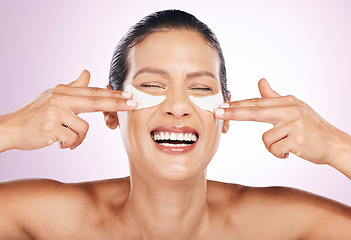 Image showing Laughing, skincare and woman with eye patches in studio isolated on a purple background. Collagen cosmetics, dermatology and funny, smile and mature female model apply mask for healthy skin treatment