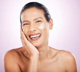 Image showing Face, cream and skincare of woman laughing in studio isolated on a purple background. Mature, portrait and happy female model with dermatology lotion, creme and moisturizer cosmetics for anti aging.