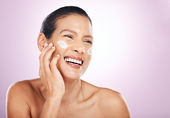 Image showing Face smile, cream and skincare of woman in studio isolated on a purple background. Mature, thinking and happy female model with dermatology lotion, creme and moisturizer cosmetics for healthy skin.