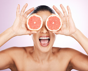 Image showing Face laughing, grapefruit and skincare of woman in studio isolated on a purple background. Natural cosmetics, food and happy mature female model with fruit for vitamin c, nutrition and healthy diet.