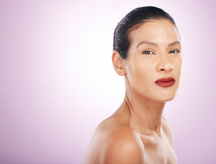 Image showing Face, makeup and red lipstick of woman in studio isolated on a purple background mockup. Skincare, cosmetics and portrait, serious and mature female model with lip gloss for skin aesthetic and beauty