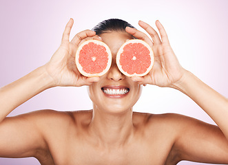 Image showing Face smile, grapefruit and skincare of woman in studio isolated on a purple background. Natural cosmetics, food and happy mature female model with fruit for vitamin c, nutrition and healthy diet.