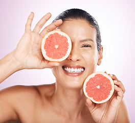 Image showing Face smile, grapefruit and skincare of woman in studio isolated on a purple background. Natural cosmetics, portrait and happy mature female model with fruit for vitamin c, nutrition or healthy diet.