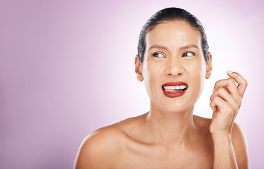 Image showing Face, makeup idea and lipstick of woman in studio isolated on a purple background. Skincare cosmetics, thinking or happy, tongue out and mature female model with red lip gloss for skin glow or beauty