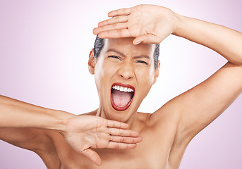 Image showing Portrait, beauty and a screaming woman in studio on a pink background for skincare or expression. Face, hands and emotion with an attractive young female shouting for natural treatment or cosmetics