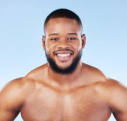 Image showing Body care, portrait and man in studio for cleaning, grooming or hygiene against blue background. Face, shower and male wellness model relax for beauty, routine and self care while posing isolated