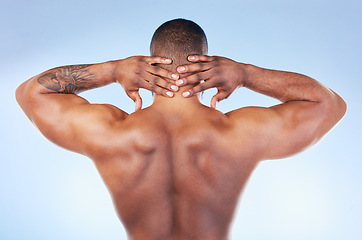 Image showing Back, muscle and black man touching neck or head as self love, skincare and isolated in a studio blue background. Health, wellness and strong muscular bodybuilder or model embracing skin