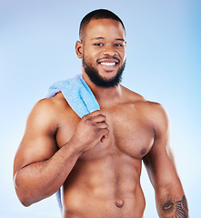 Image showing Towel, shower and skincare portrait of a black man with happiness from bodybuilder muscle. Cleaning, self care and wellness from gym workout and exercise with isolated, studio and blue background