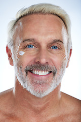 Image showing Old man, cream and portrait, face with skincare and beauty, hygiene with grooming on studio background. Lotion, moisturizer and dermatology, anti aging cosmetic care and senior male and smile