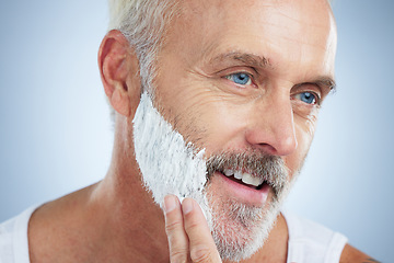 Image showing Mature man, face and shaving cream for grooming, skincare or hair removal against studio background. Closeup of senior male applying shave creme, cosmetics or product for haircare or facial treatment