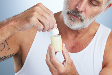 Image showing Beauty, skincare and face serum with man in studio for anti aging, cosmetics and spa treatment. Product, facial and hyaluronic acid with senior model on gray background for wrinkles, retinol or relax